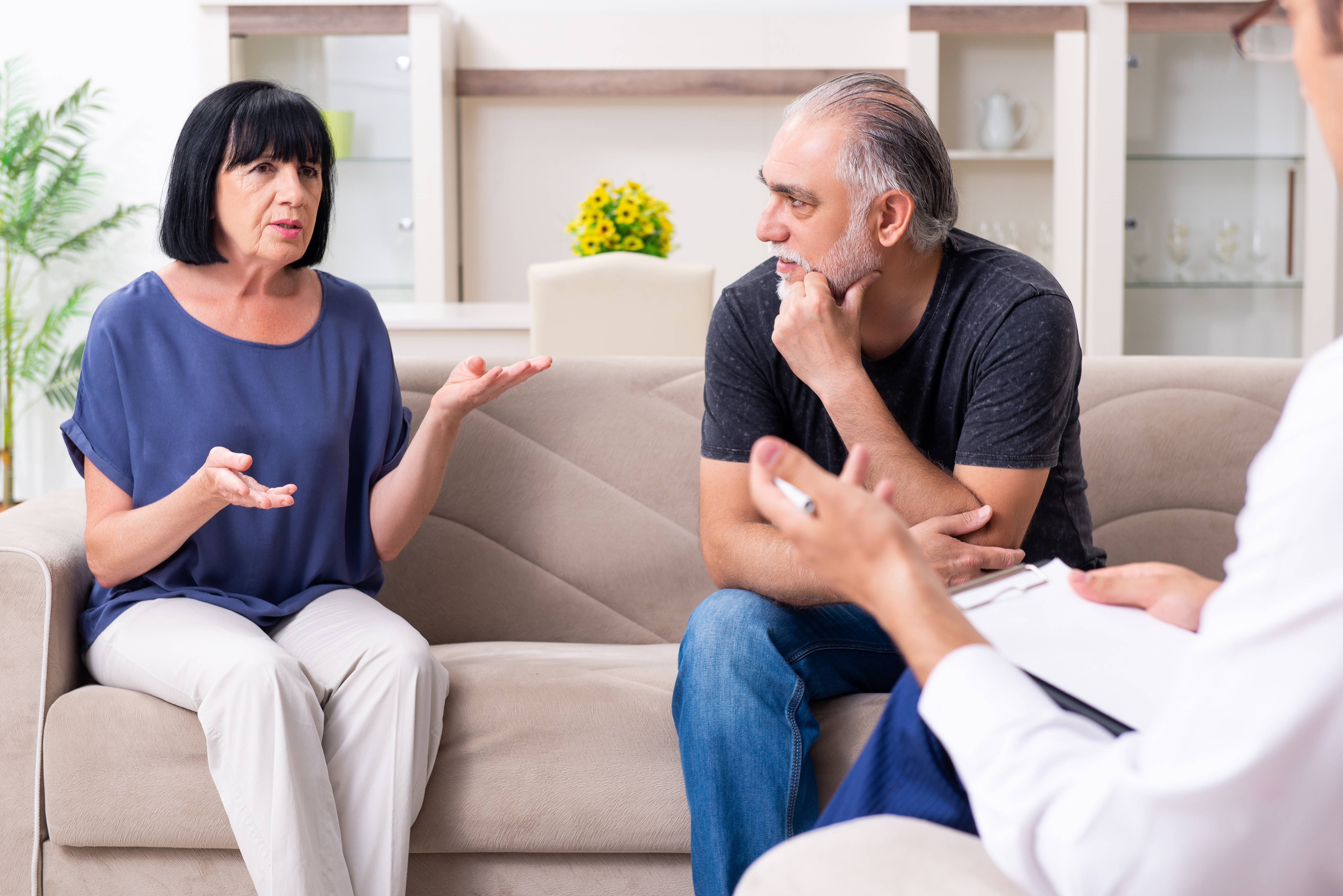 Couple sitting on a sofa  receiving couples therapy