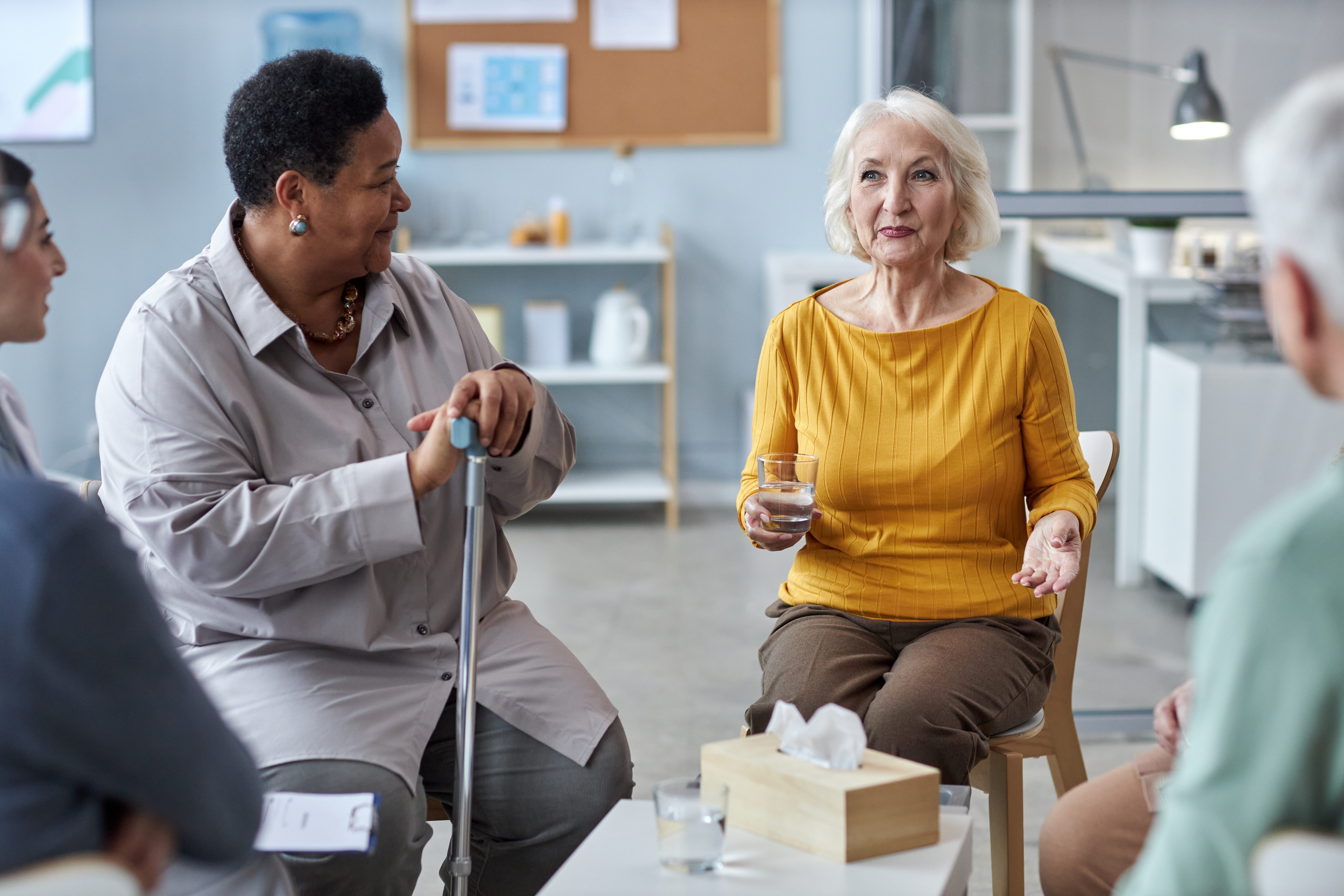 Group of people talking at a support group