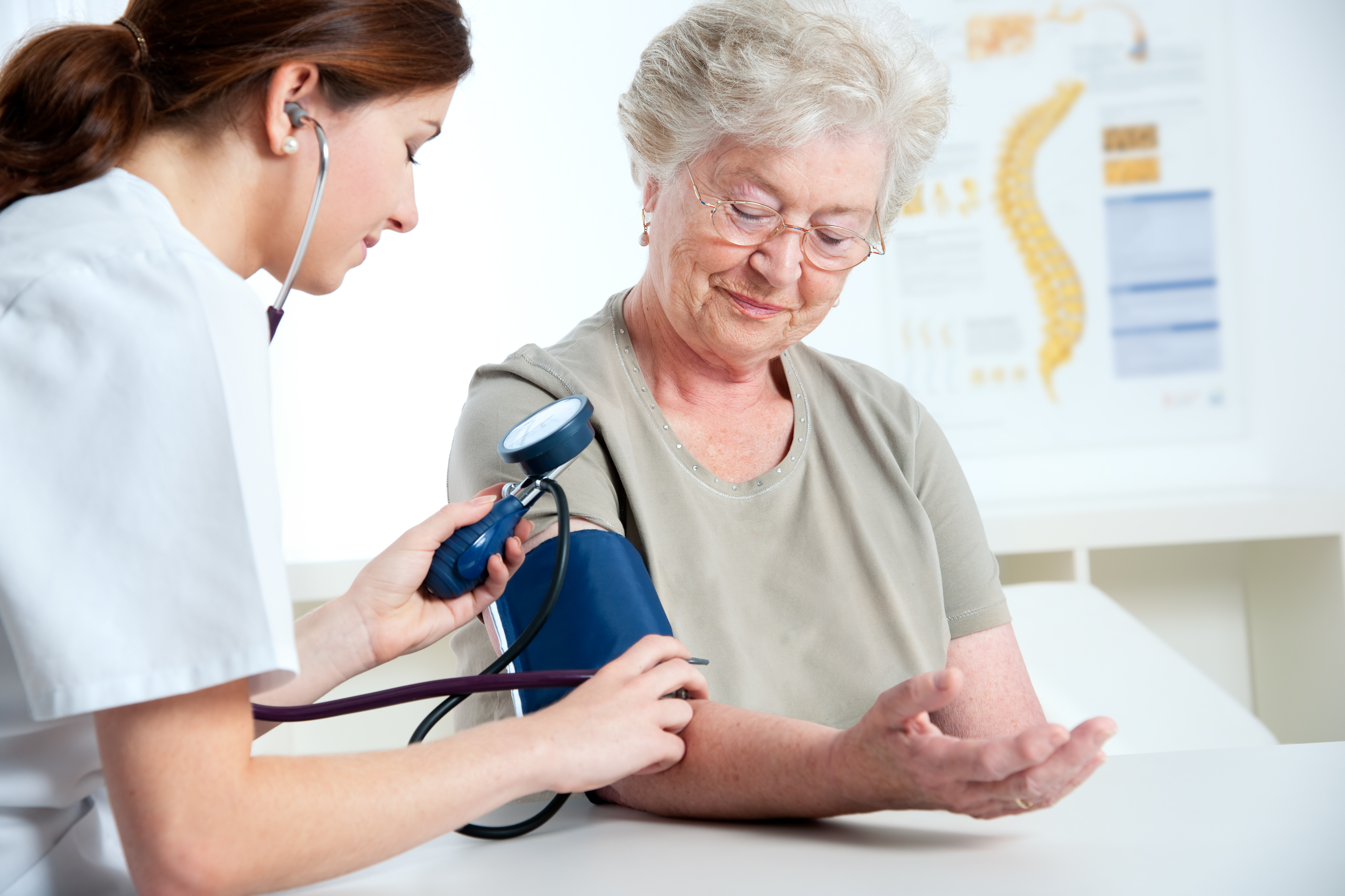 Older woman having blood pressure checked by nurse