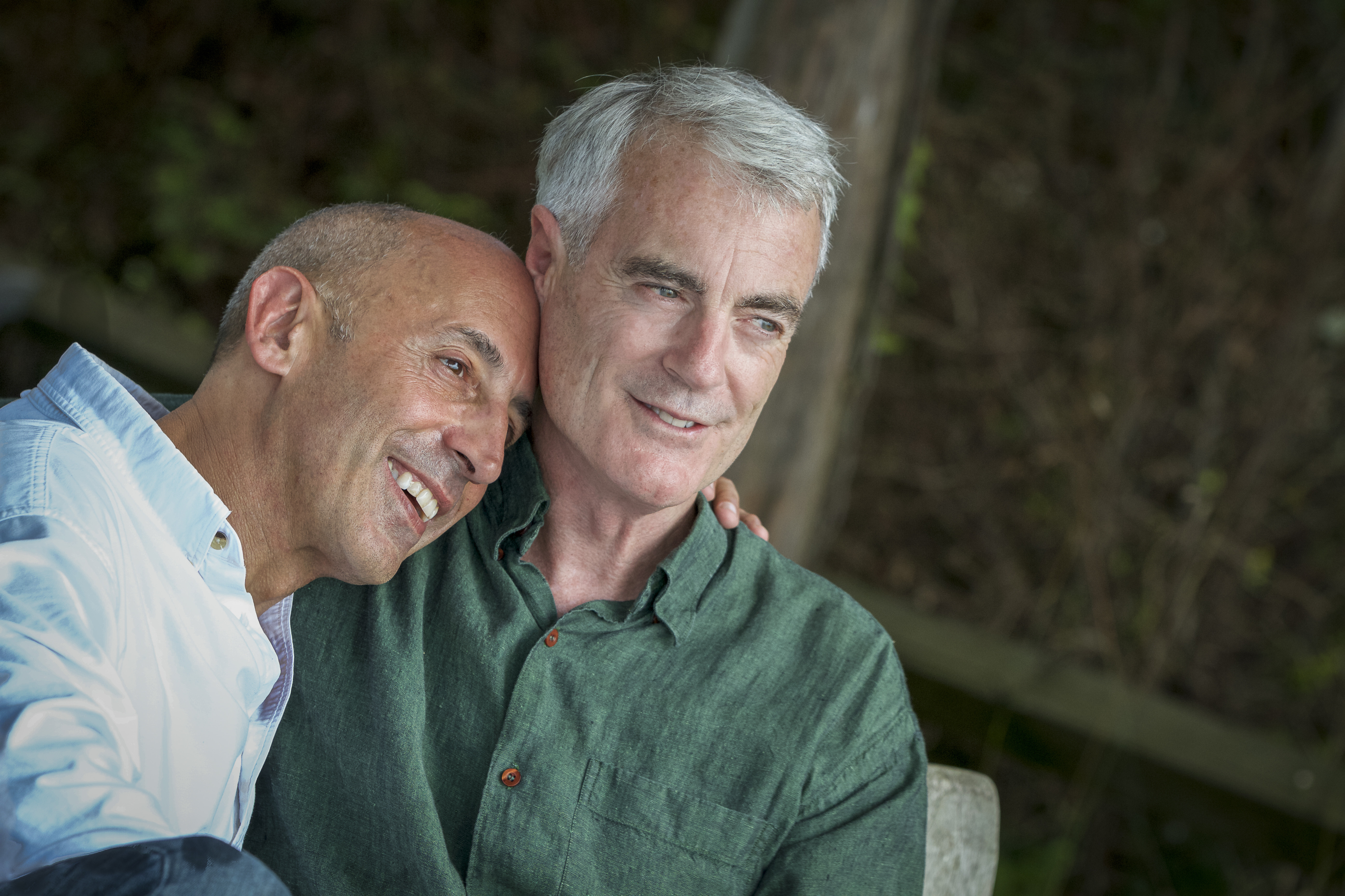 Male couple with one man resting his head on the others shoulder