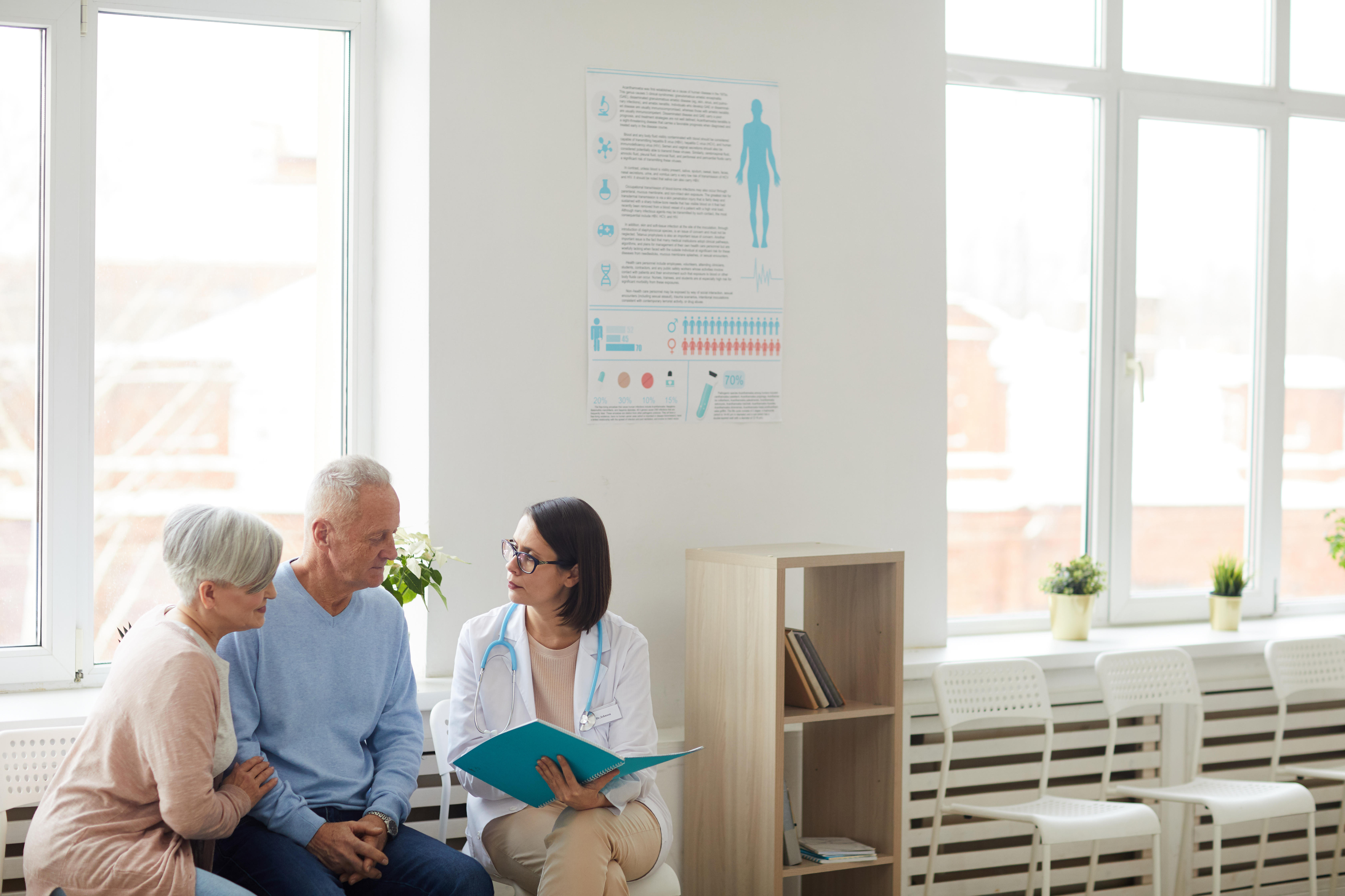 Female doctor talking to couple