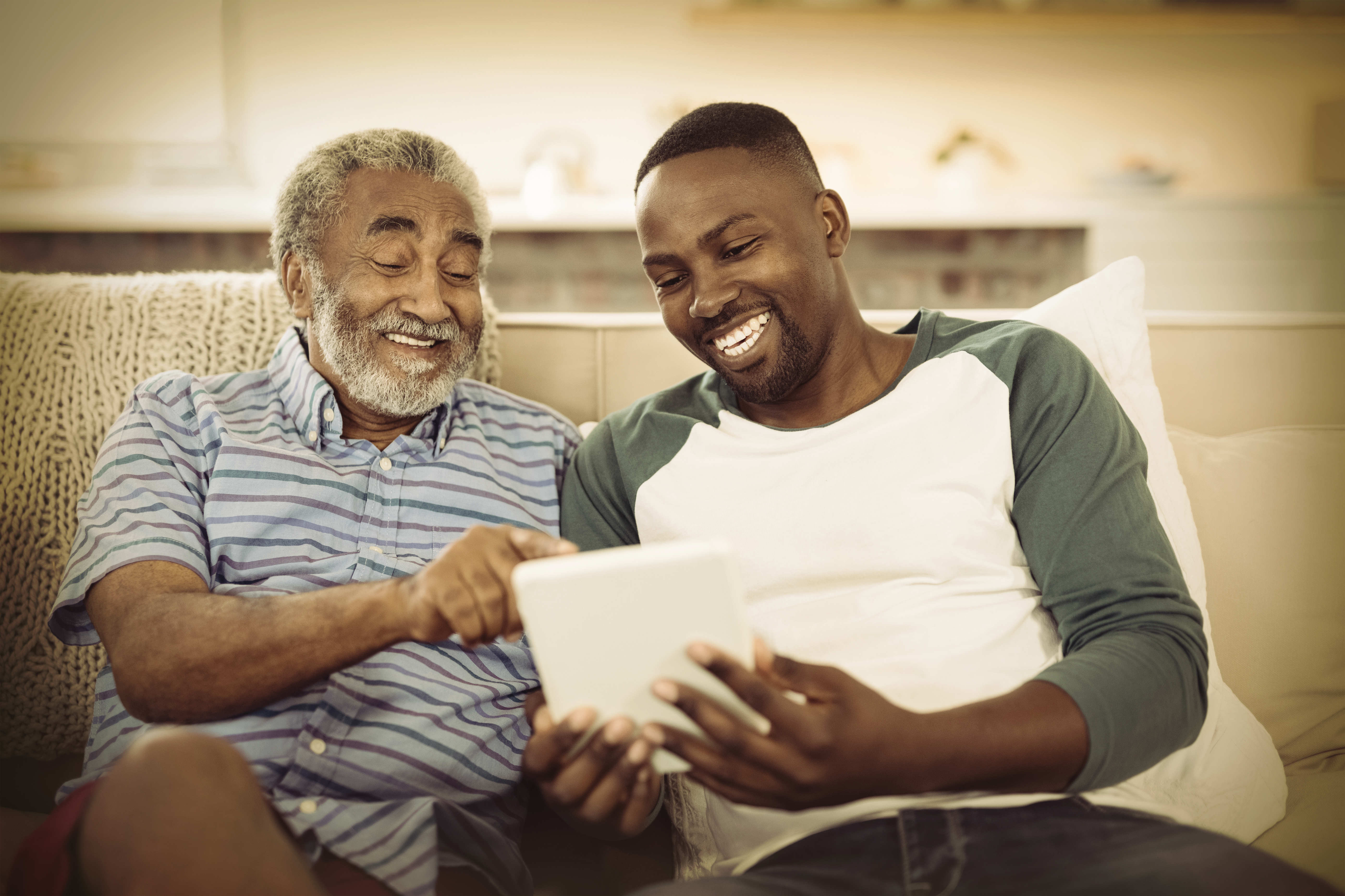 Black Father and son looking at an iPad