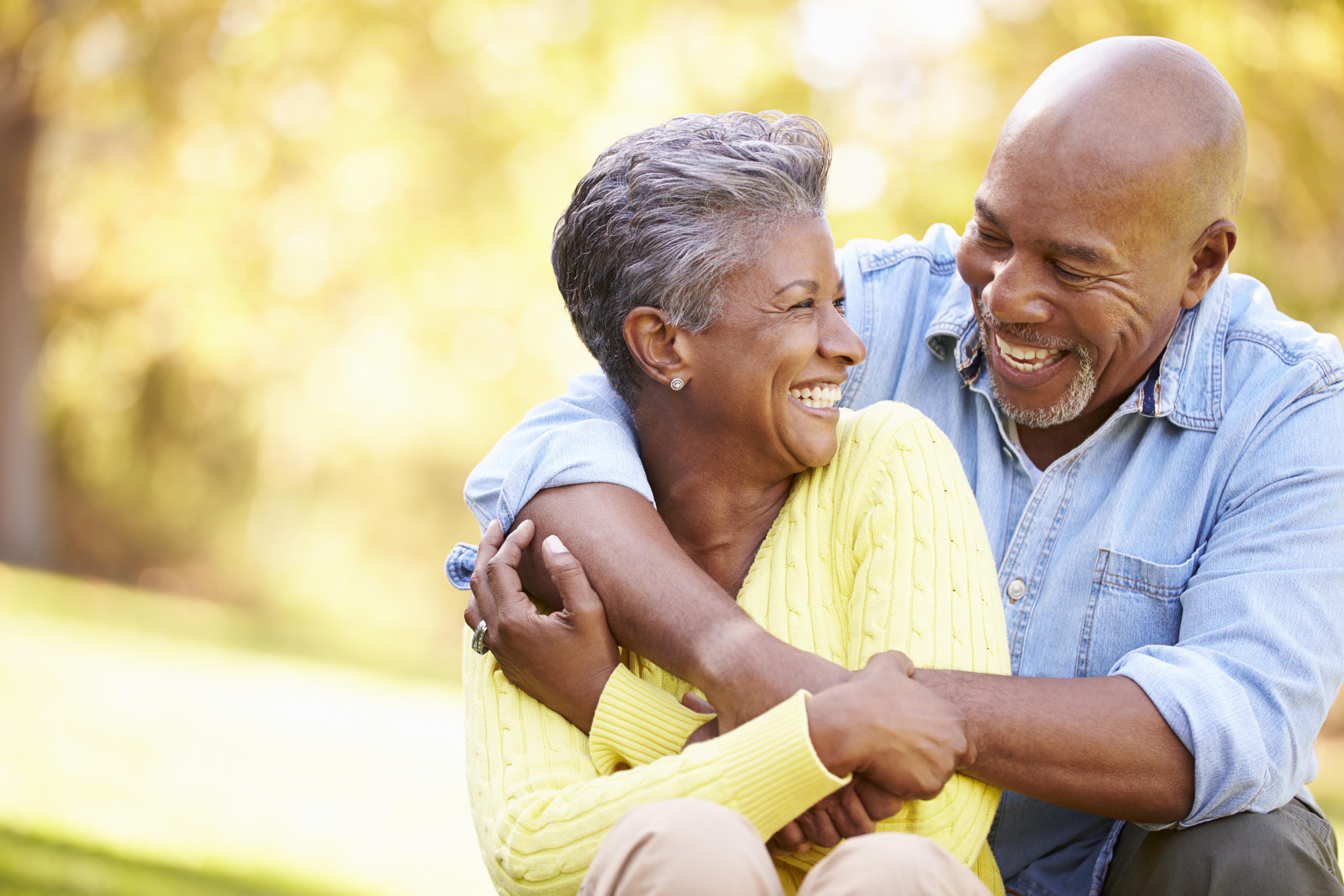 Black couple embracing and smiling