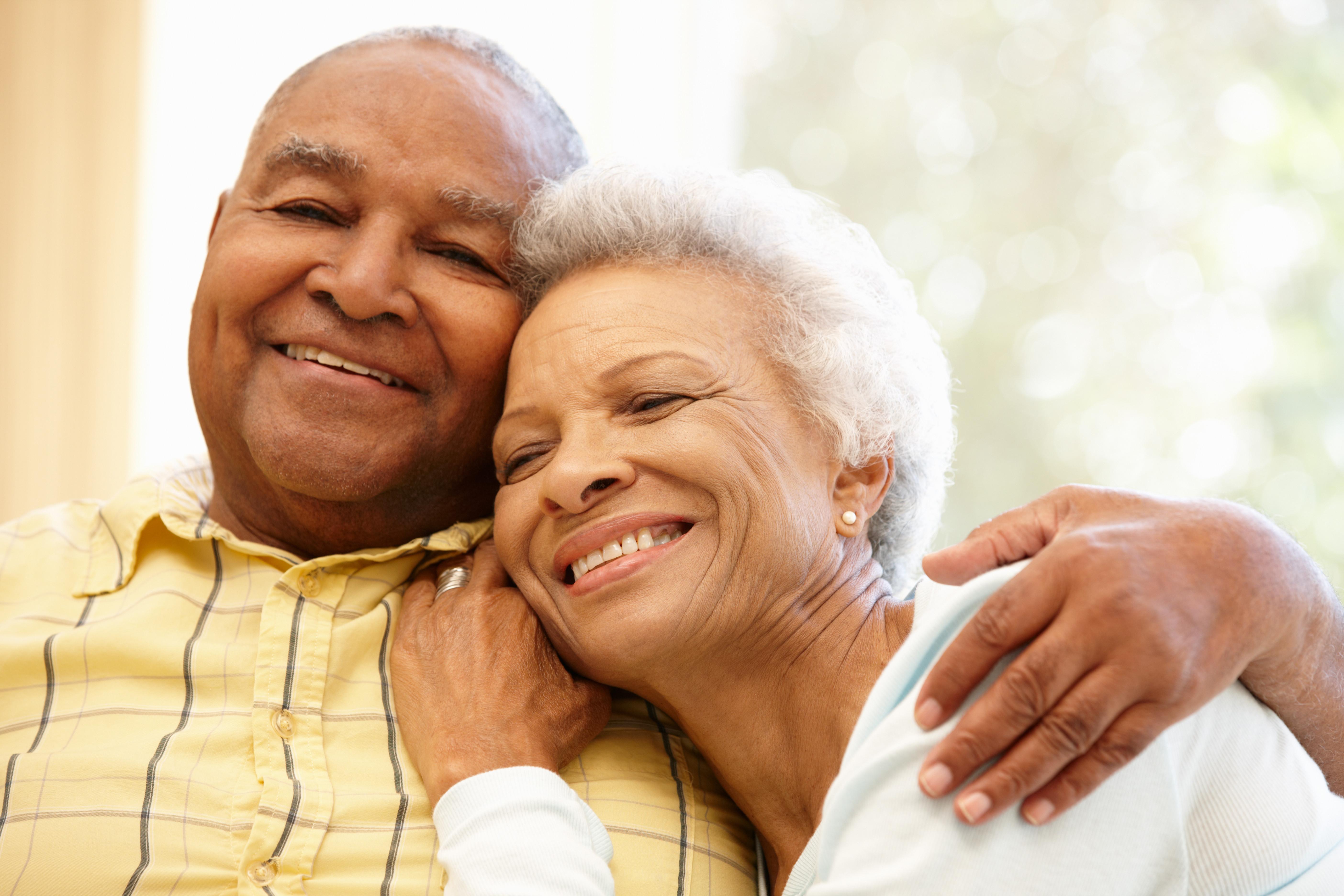 Older man with arm around his partner.